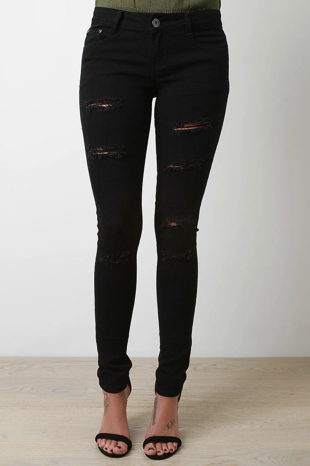 Sliced Distressed Mid Rise Skinny Jeans